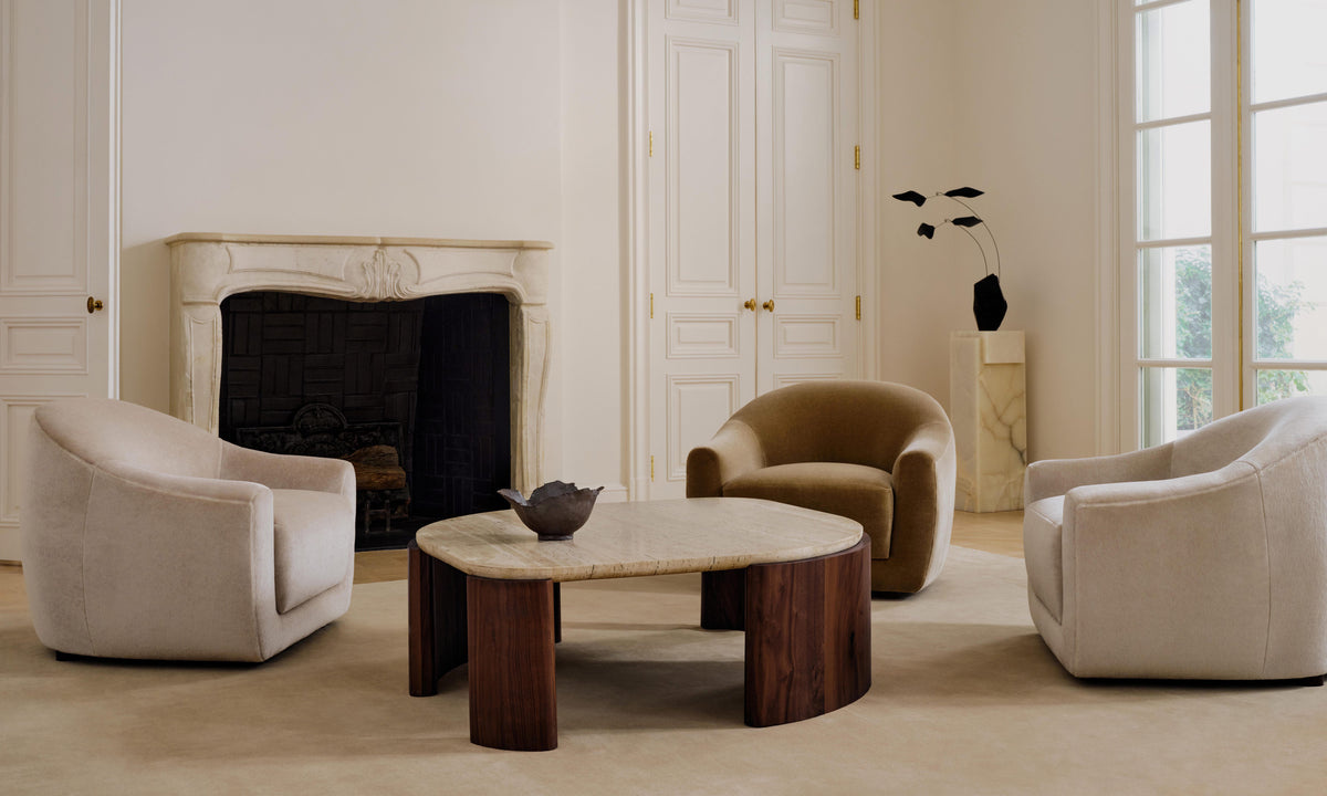 travertine stone top coffee table and accent chairs in a modern living room