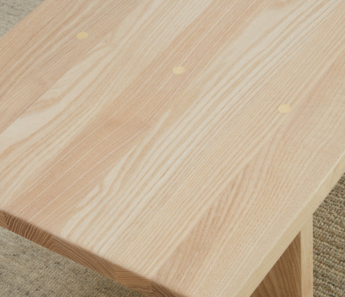 Close up of the top of the Reyes Bench in Nubuck Leather in the color Sail finished in Natural Ash.