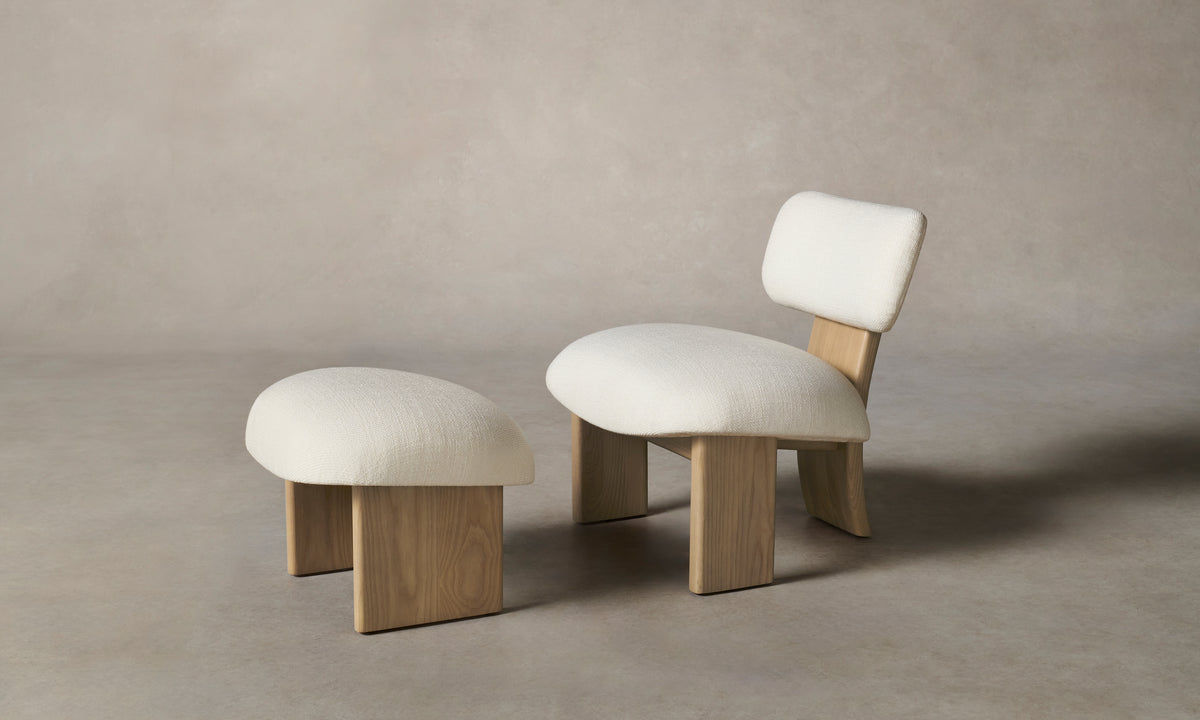 kenmare accent chair in white linen with ash wood curved frame and an ottoman